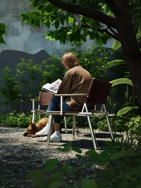 Personne lisant dans un jardin paisible avec son chien sous un arbre