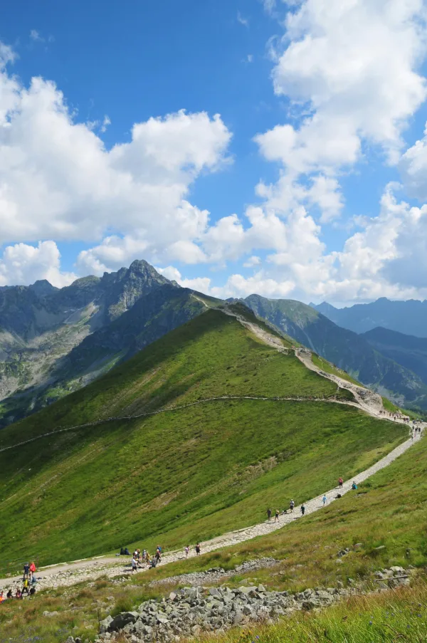 Sentier de randonnée en montagne sous un ciel bleu