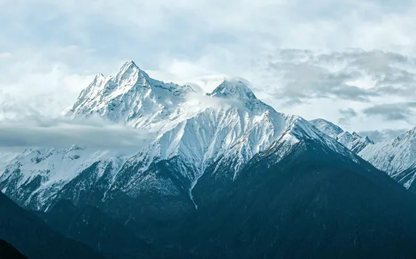 Chaîne de montagnes enneigées sous les nuages dans le paysage du Tibet